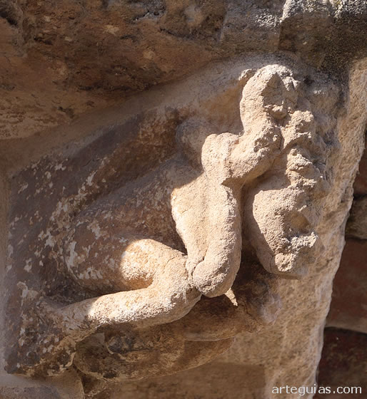 Canecillo de un hombre atacado por una serpiente