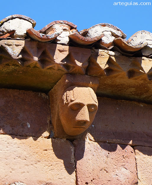 Cabeza humana en uno de los canecillos del &aacute;bside
